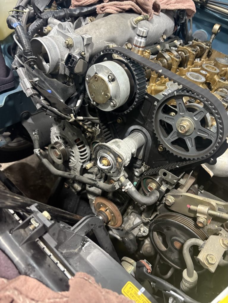 Timing belt under the hood of a vehicle